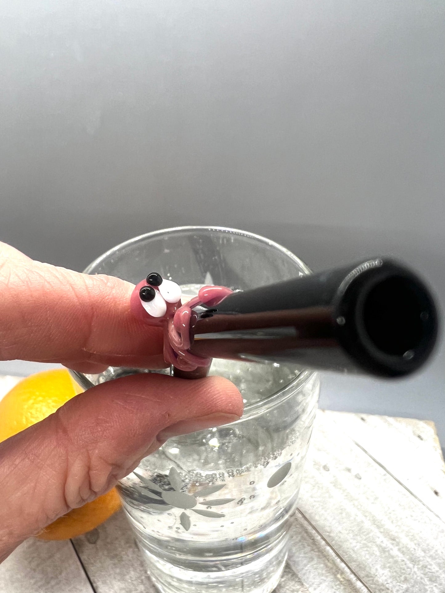 Pink Octopus on a Bent Black Straw