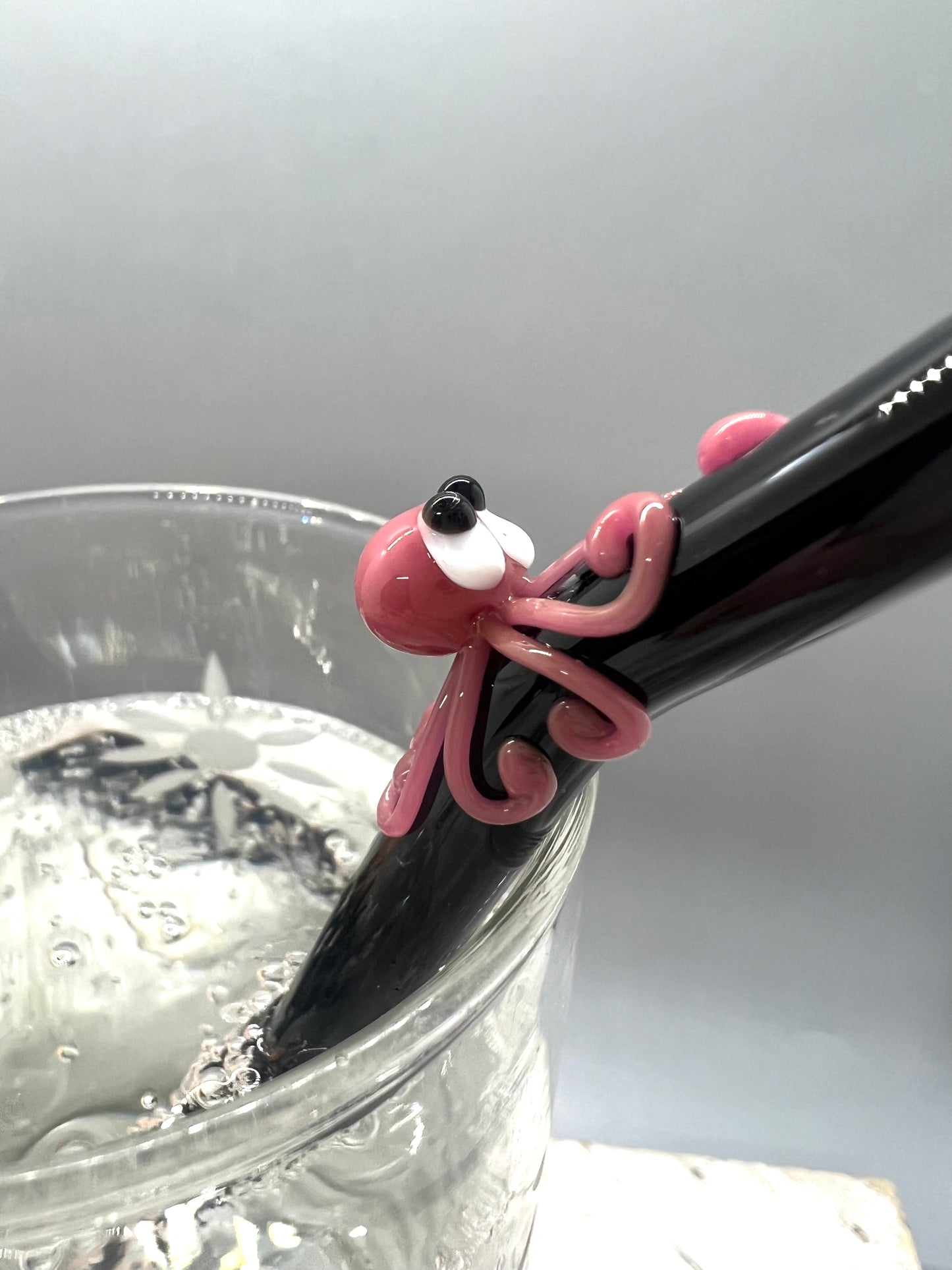 Pink Octopus on a Bent Black Straw