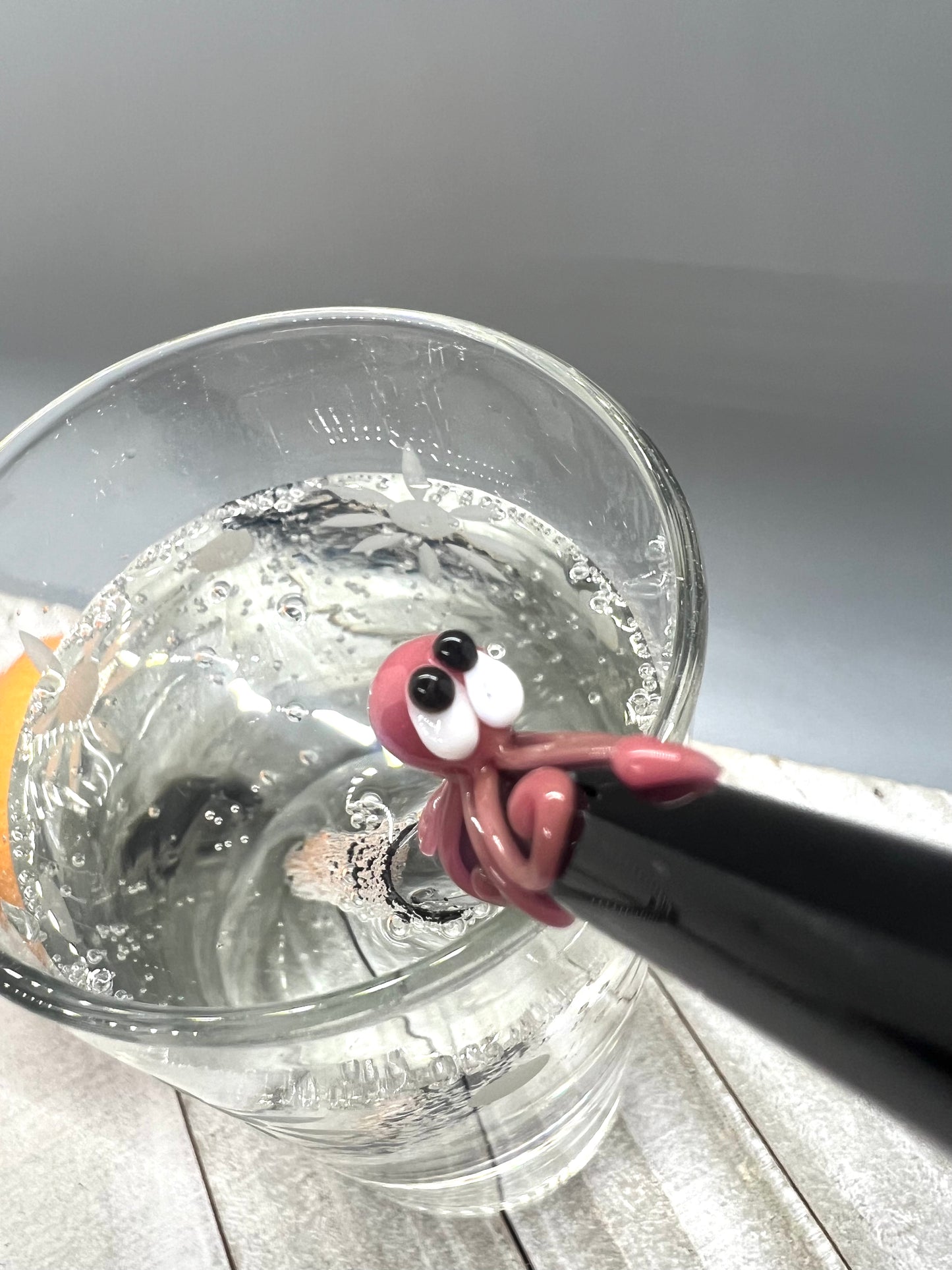 Pink Octopus on a Bent Black Straw