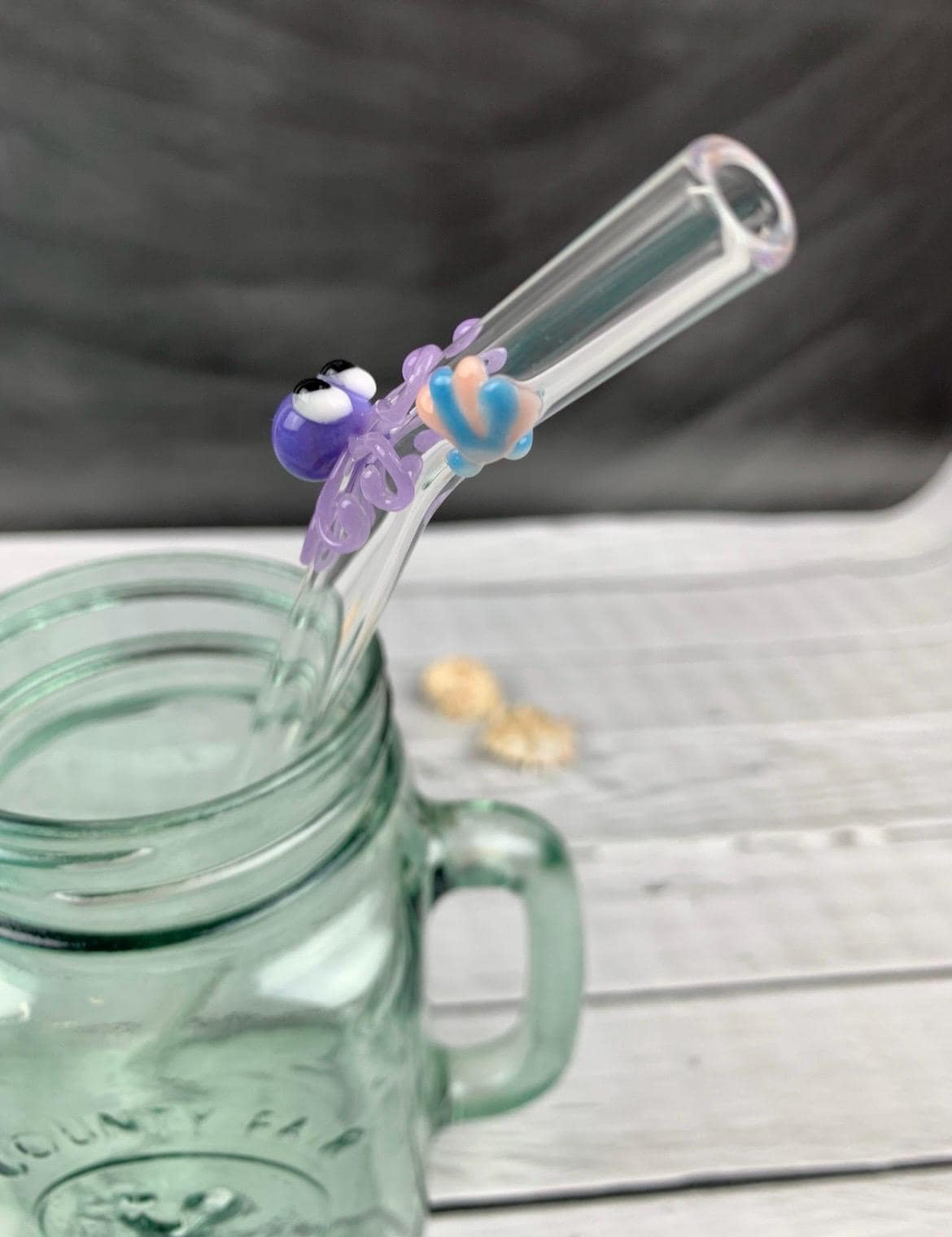 Purple Octopus and Shell on Bent Clear Glass Straw